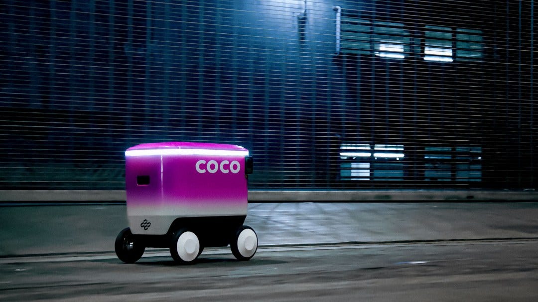 a coco robot speeding down a dark city street a coco robot speeding down a dark city street