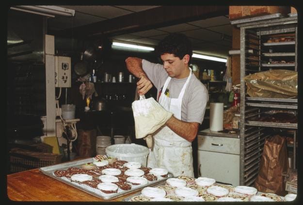 Kitchen worker prepares a batch of pastries at Barry's Pastry Shop, Lowell, Massachusetts, 1987 Kitchen worker prepares a batch of pastries at Barry's Pastry Shop, Lowell, Massachusetts, 1987