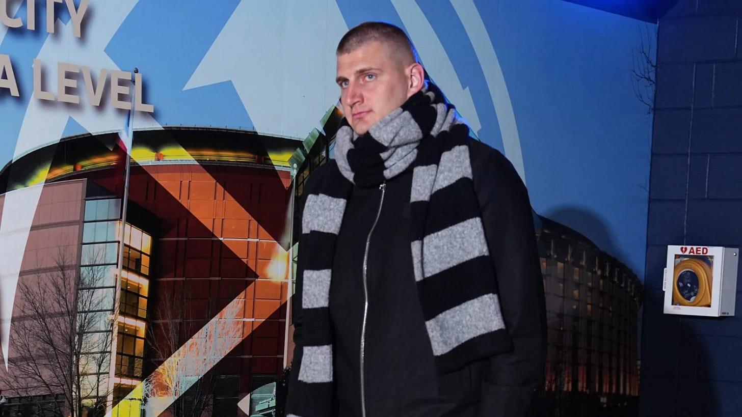 Nikola Jokic in a grey and black scarf, arriving to an NBA game Nikola Jokic in a grey and black scarf, arriving to an NBA game