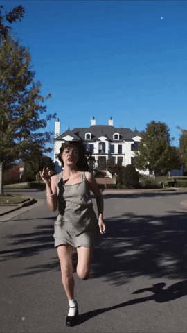 A woman runs away from a mansion