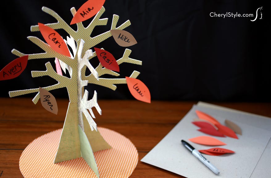 A family tree craft showing a stand up 3D tree with names written on leaves glued to the branches.