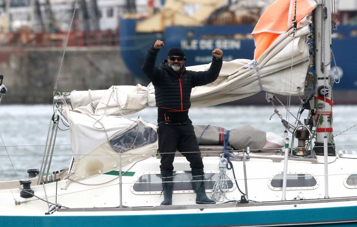 juan manuel ballestero stands on his boat after sailing across the atlantic ocean to see his father