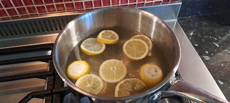1. Bowl piled high with elderflowers beside a chopping board and lemons. 2. Sugar solution with sliced lemons in a stainless steel pan. 3. Elderflowers submerged in the sugar/ lemon solution.