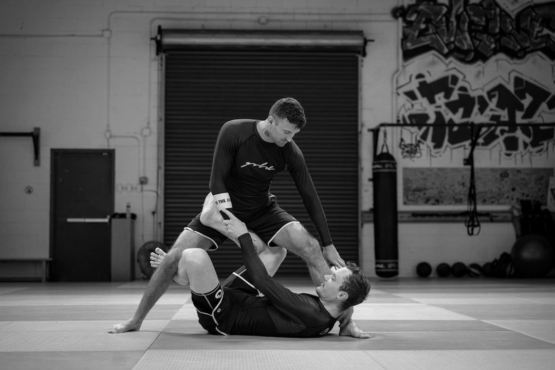 a couple of men standing on top of each other in a gym a couple of men standing on top of each other in a gym