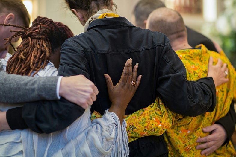 A group of individuals hugging in a circle representative of different cultures/places in the world. A group of individuals hugging in a circle representative of different cultures/places in the world.