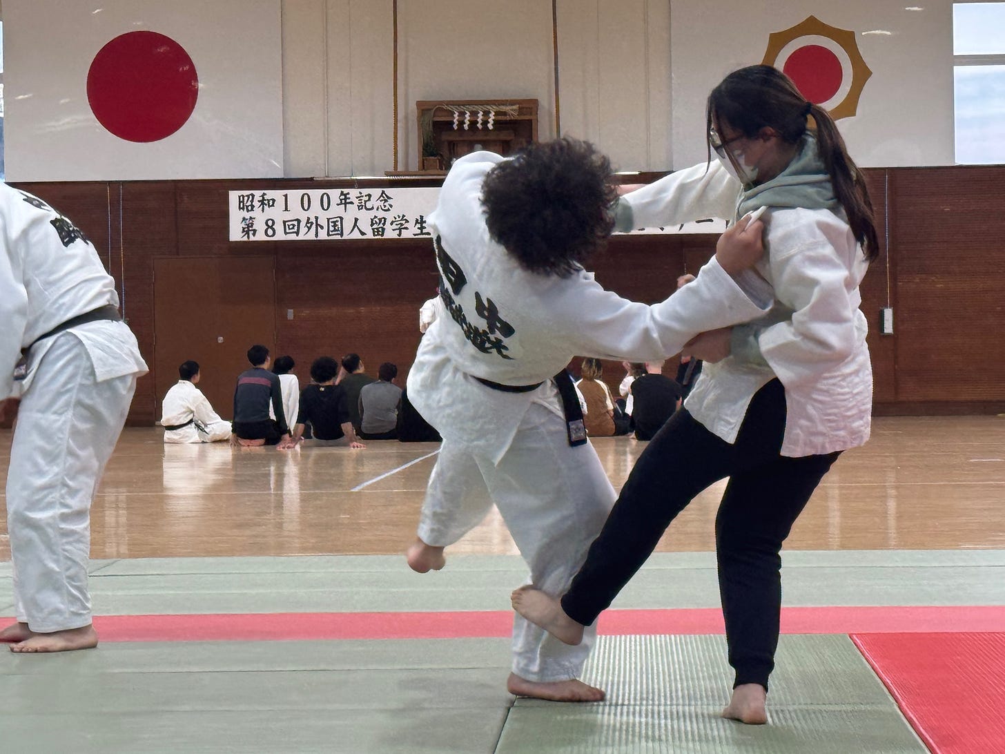 A couple of people in karate uniforms

AI-generated content may be incorrect.