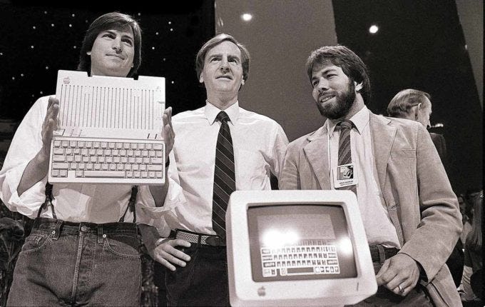 Steve Jobs, John Sculley, and Steve Wozniak present the Apple II, symbolizing the dominance of location-based startup strategy in Silicon Valley's golden era. Steve Jobs, John Sculley, and Steve Wozniak present the Apple II, symbolizing the dominance of location-based startup strategy in Silicon Valley's golden era.