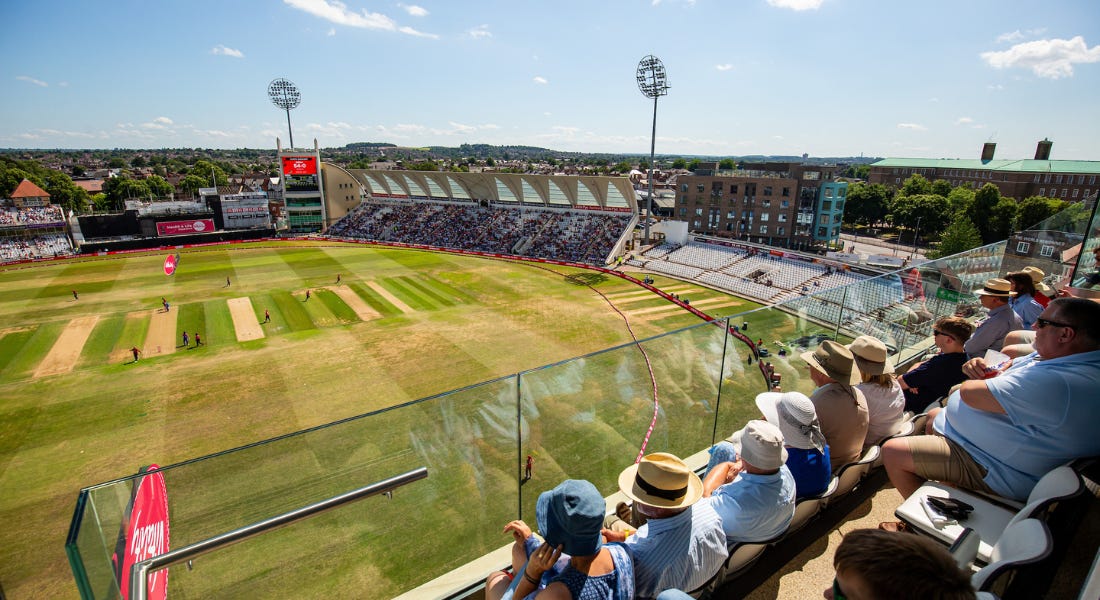 A view from Trent Bridge's stand of the cricket pitch and the wider area, with people sat in seats in front of this