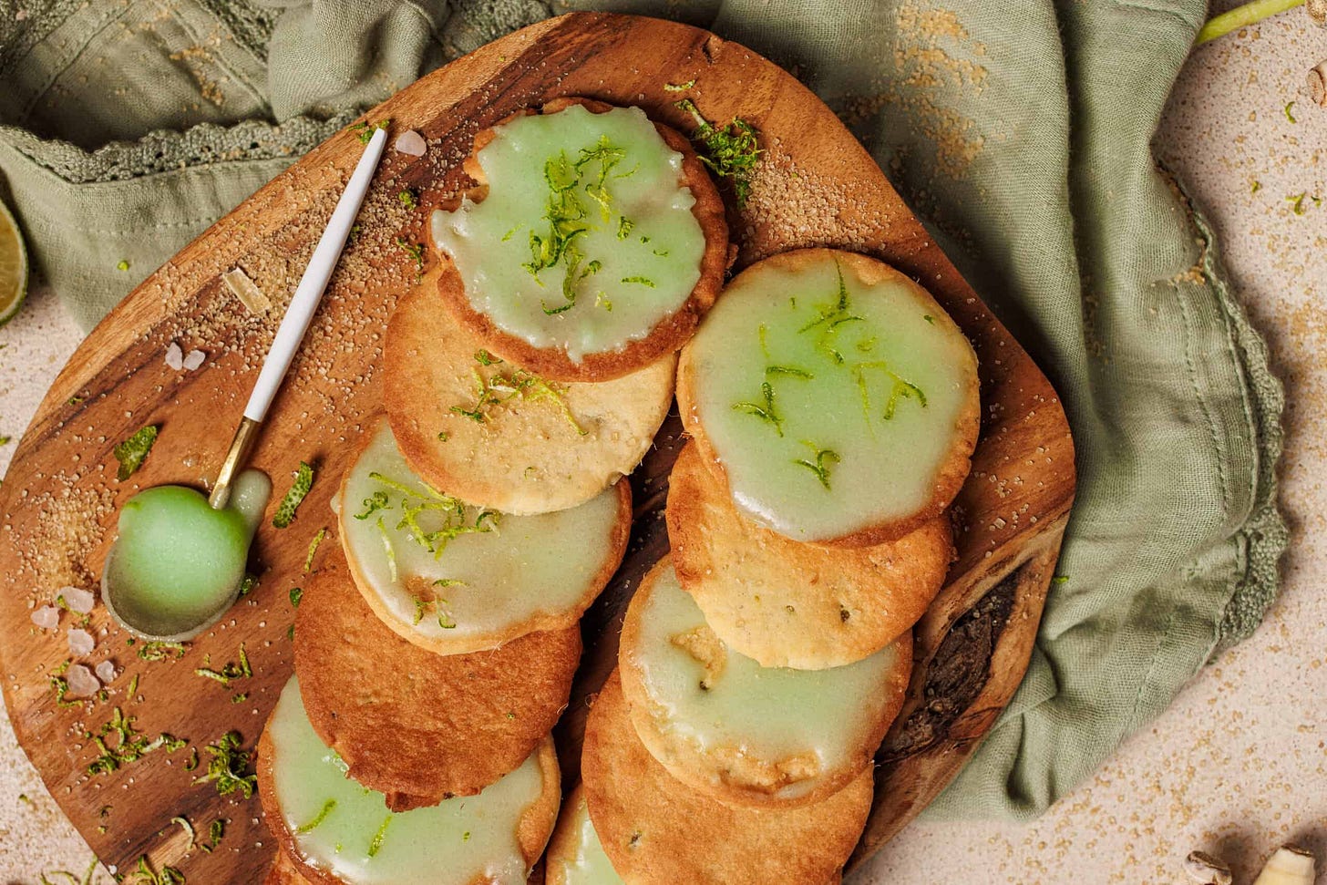 Freshly baked lemongrass cookies with green icing and lime zest. 