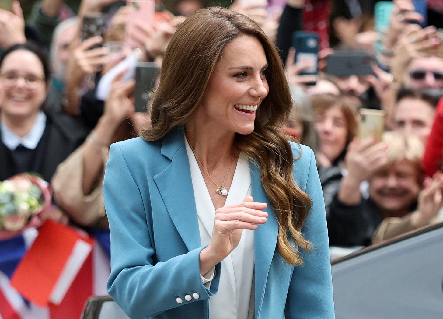 Princess Catherine smiling in a blue suit