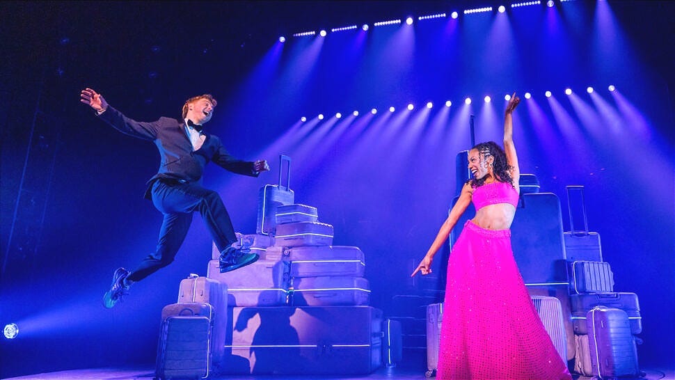 A man in a tuxedo leaps in the air towards a woman in a pink gown A man in a tuxedo leaps in the air towards a woman in a pink gown