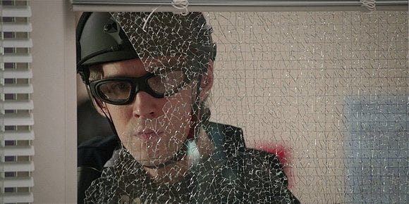 Walker Swat guy looking through broken glass from gun shot. Walker Swat guy looking through broken glass from gun shot.