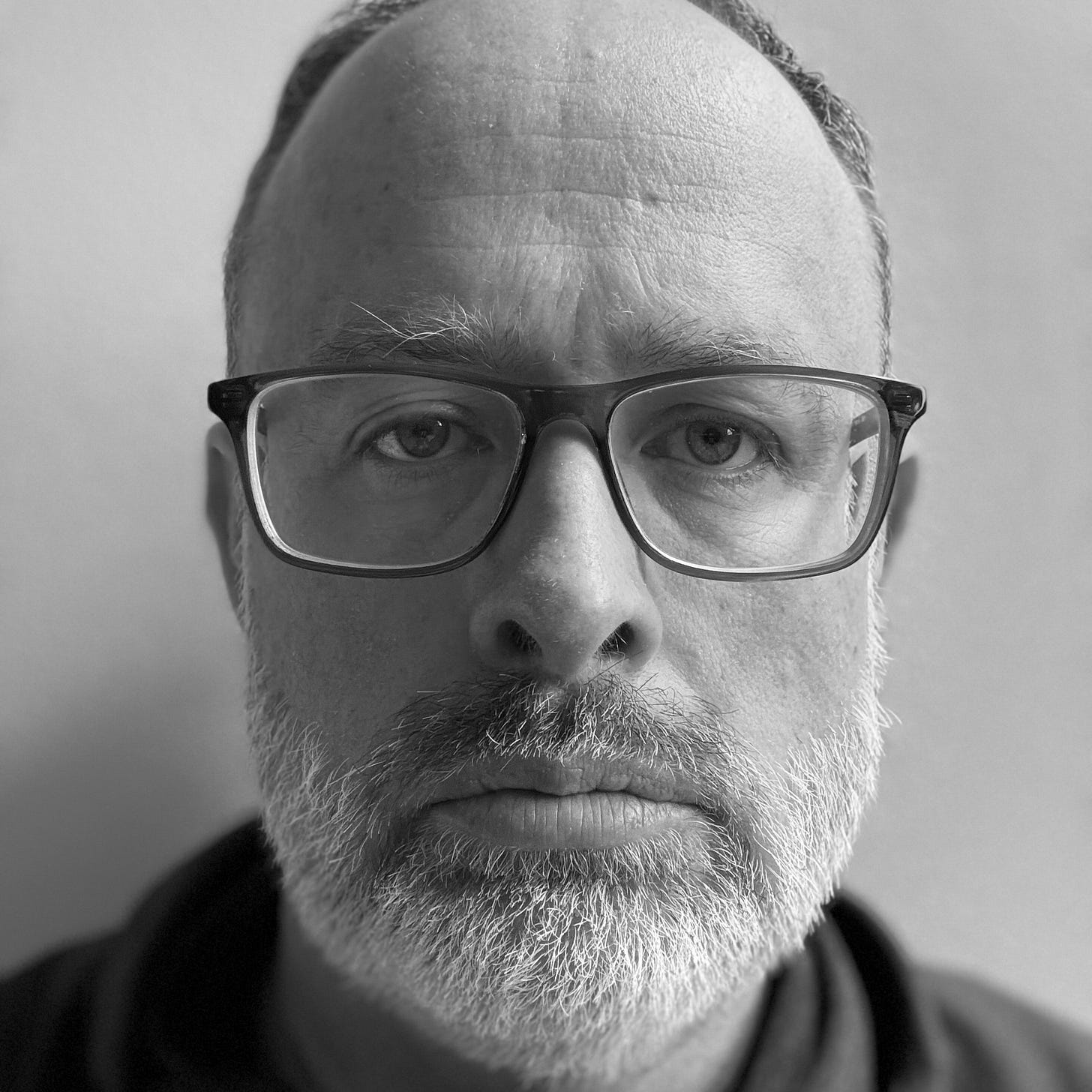 Close-up of the author, unsmiling, in black and white. A moment of stillness in the midst of emotional freeze.