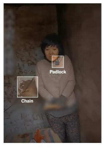 Image of woman chained by the neck in a shed in china. Highlighting chain and padlock in the image. 