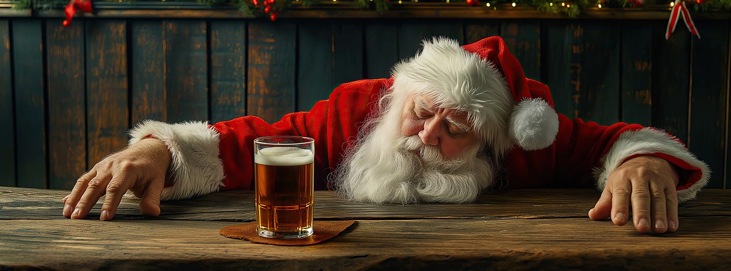 drunk Santa with his head on a bar and a beer in front of him