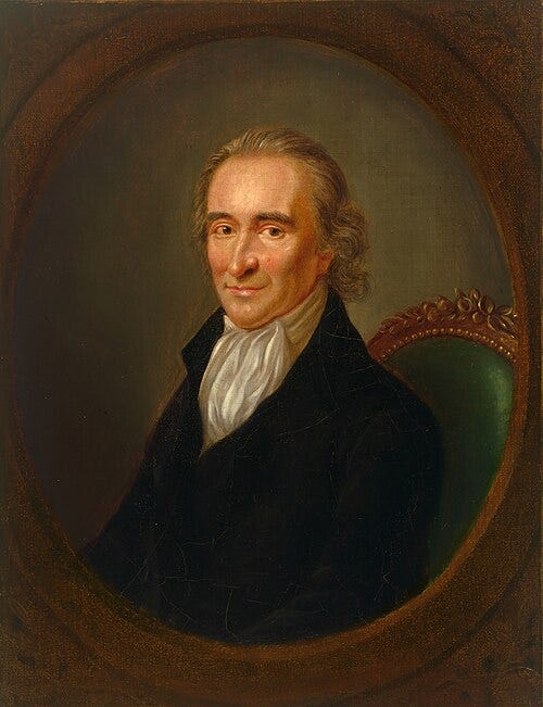 Oval oil portrait of Thomas Paine as an older man, seated in a green upholstered chair. He has gray hair and looks directly at the viewer with a slight smile, wearing a dark coat over a white cravat.