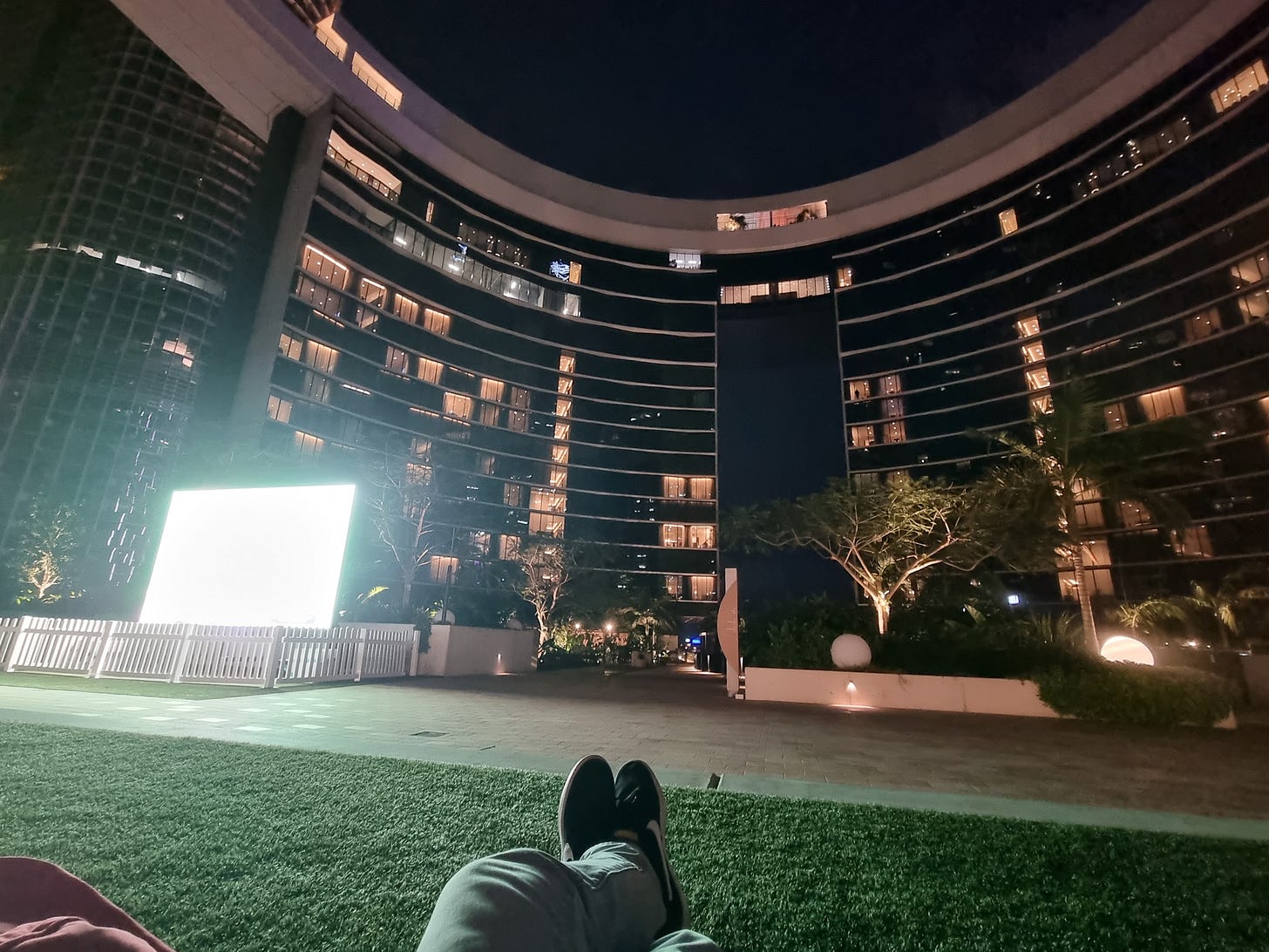 A photo of an outdoor TV in a casino courtyard.