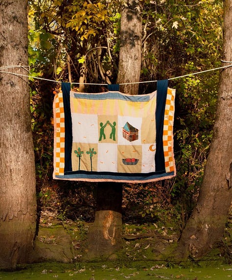 An assortment of textile art and patchwork dresses made by Sarah Nsikak.