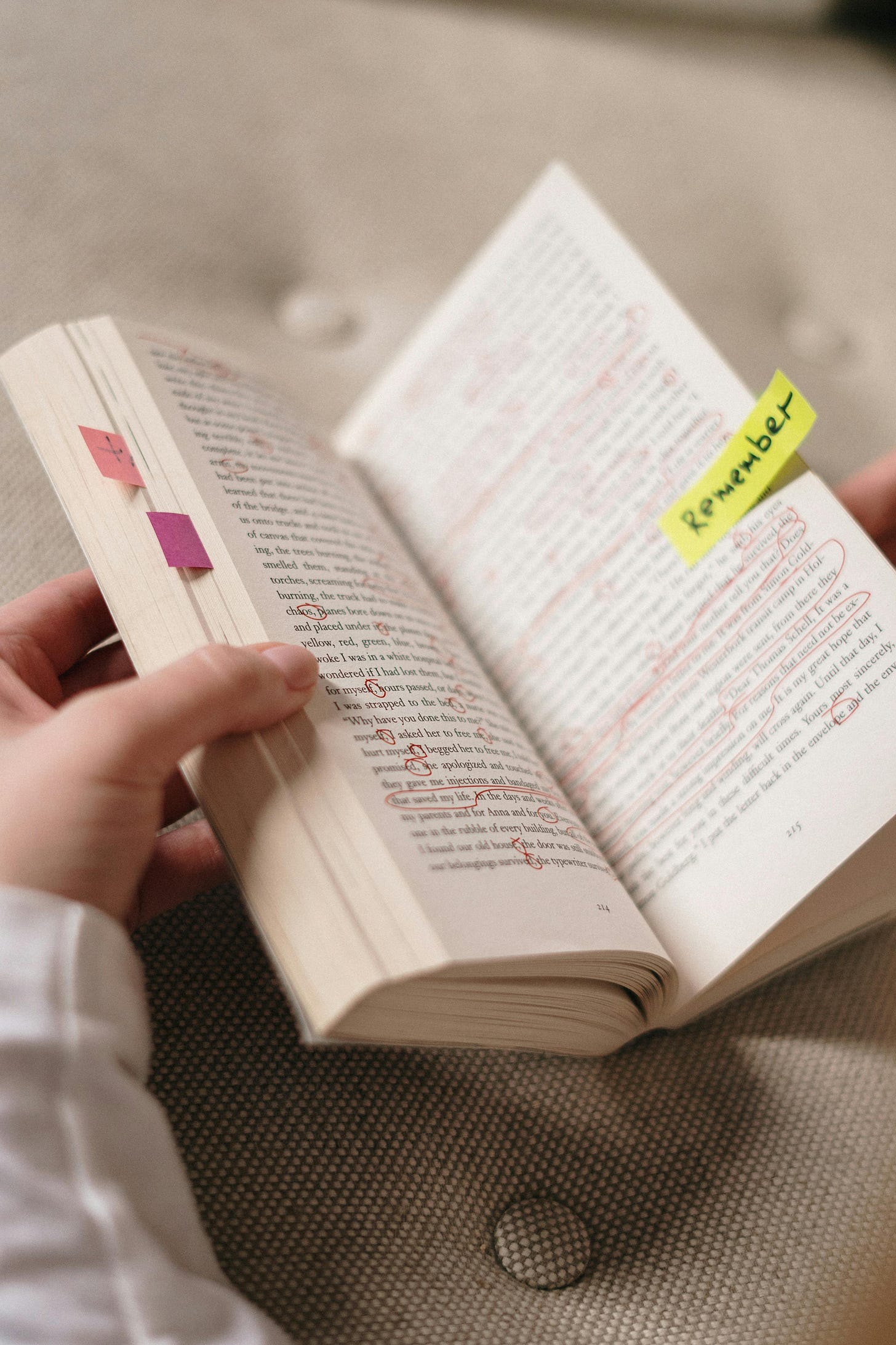 Free Close-up of a book with annotations and sticky notes with 'Remember'. Stock Photo