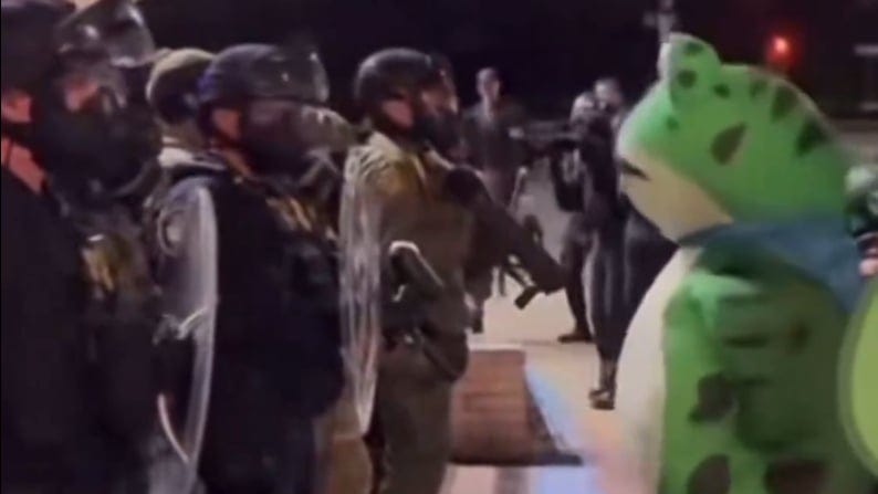 Seth Todd in a frog costume standing across from armed officers.