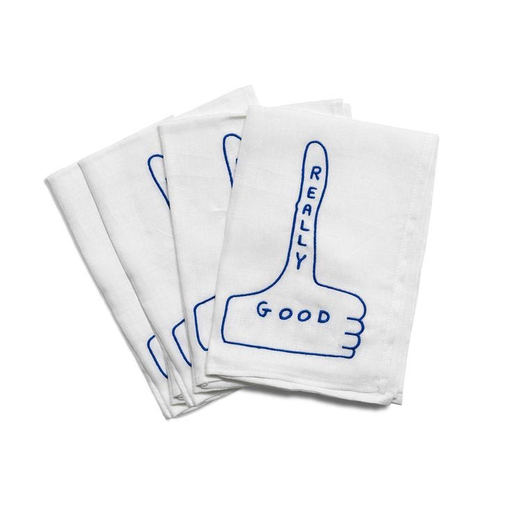 This may contain: three white napkins with blue hand prints on the front and back of each one