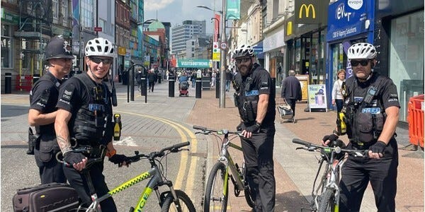 Four police officers with police pedal cycles in Southend City Centre