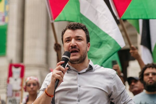 Mahmoud Khalil holding a microphone.