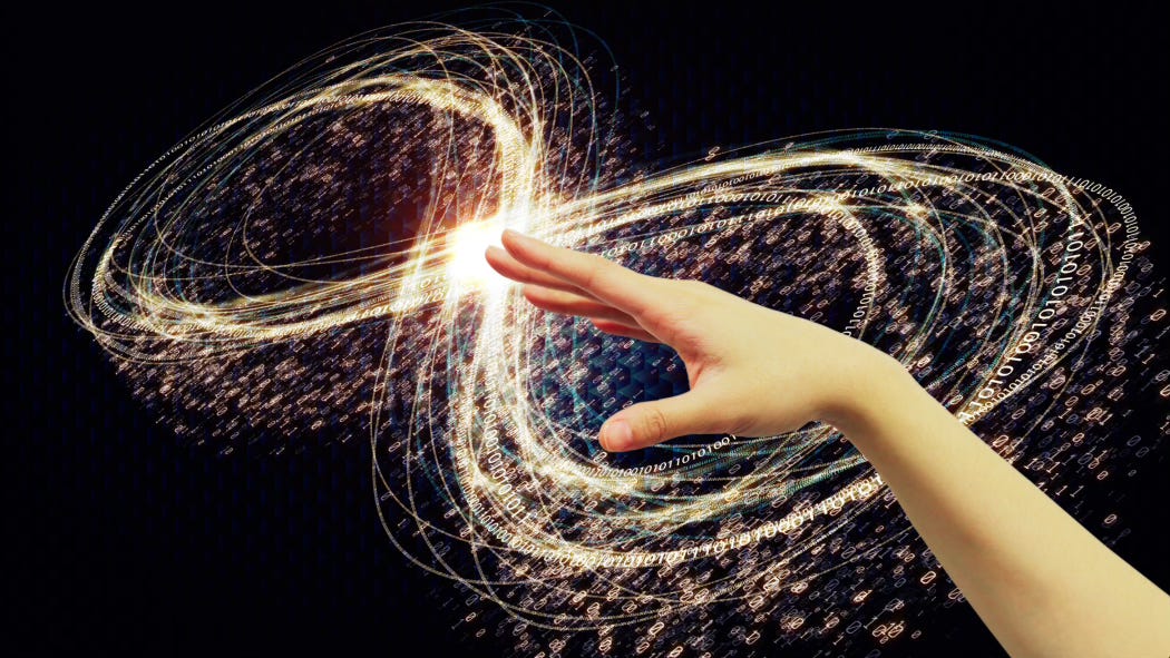 A graceful hand reaches into the black. Around and behind it swirls infinities of golden light.
