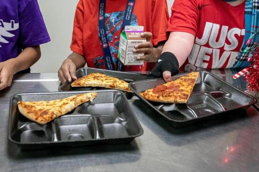 Second-grade students select their meals during their lunch break in the cafeteria, Dec. 12, 2022, at an elementary school in Scottsdale, Ariz. (Alberto Mariani/ Associated Press)