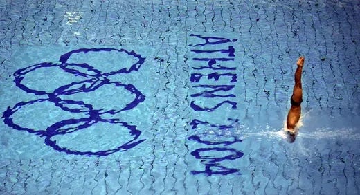An athlete dives during a training session in the Olympic aquatic center in Athens ahead of the start of the 2004 Olympic Games.