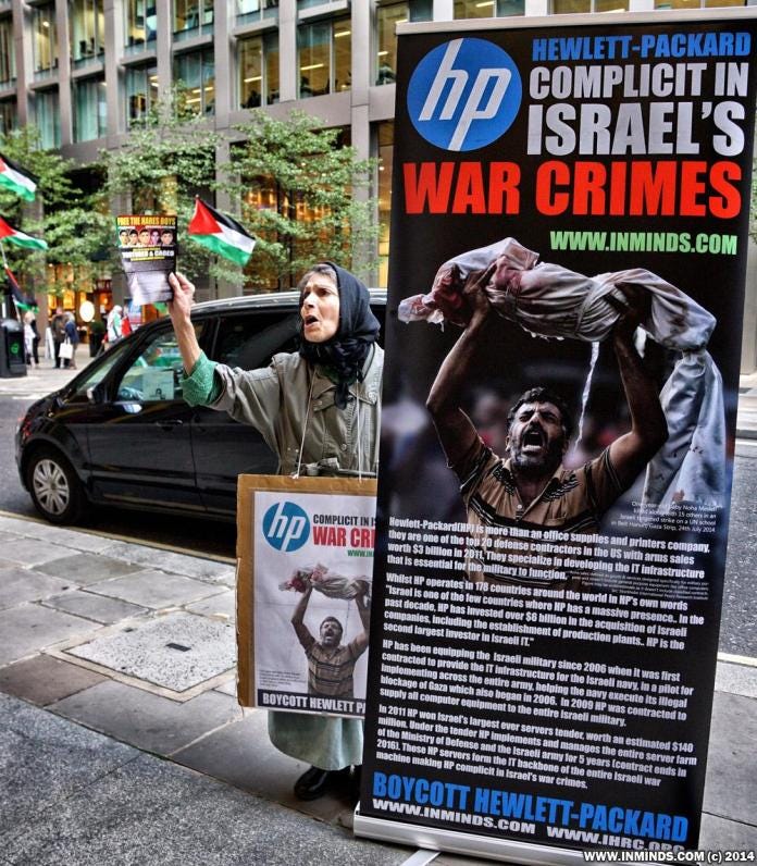 A person holding a sign next to a poster

AI-generated content may be incorrect.