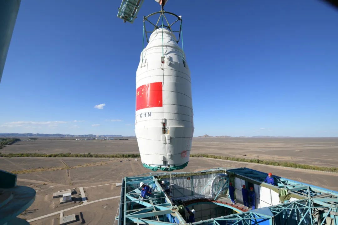 The payload fairing of the Long March 4C Y45 vehicle being lifted onto the rocket during launch preparations. The payload fairing of the Long March 4C Y45 vehicle being lifted onto the rocket during launch preparations.