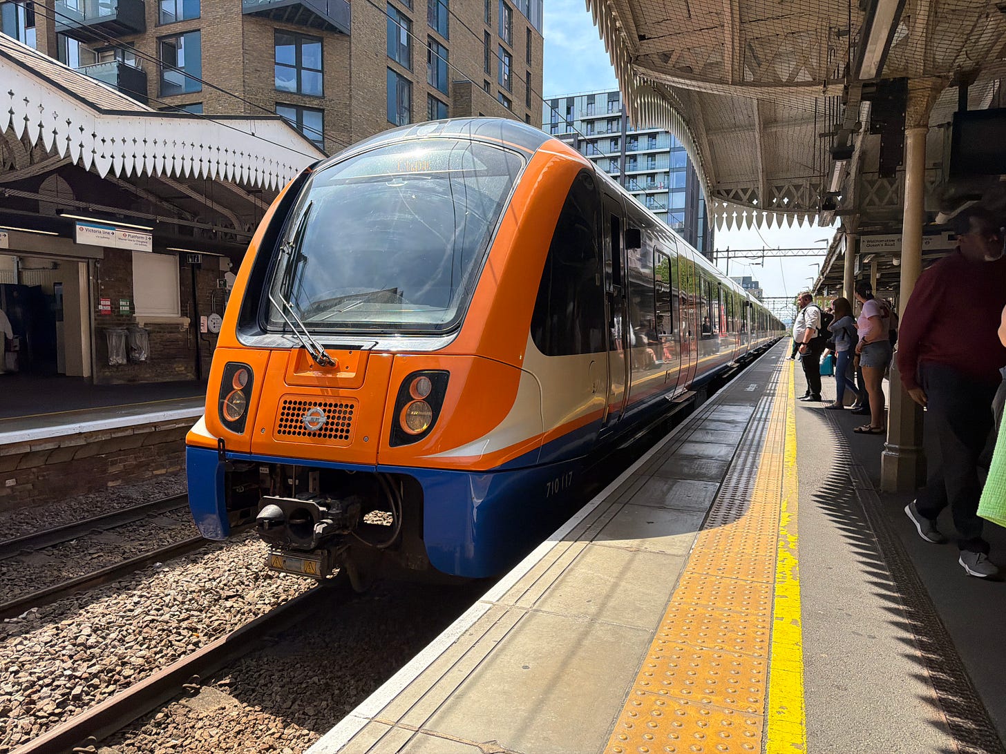 Photo of an orange Class 710 Overground train at Walthamstow Central.