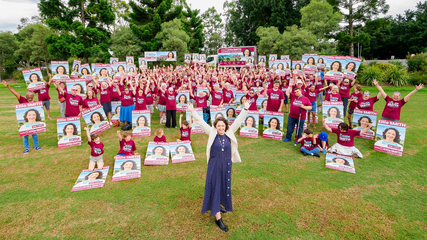 Photo of Ellie Smith standing in front of a crowd of her supporters in a park during her campaign launch