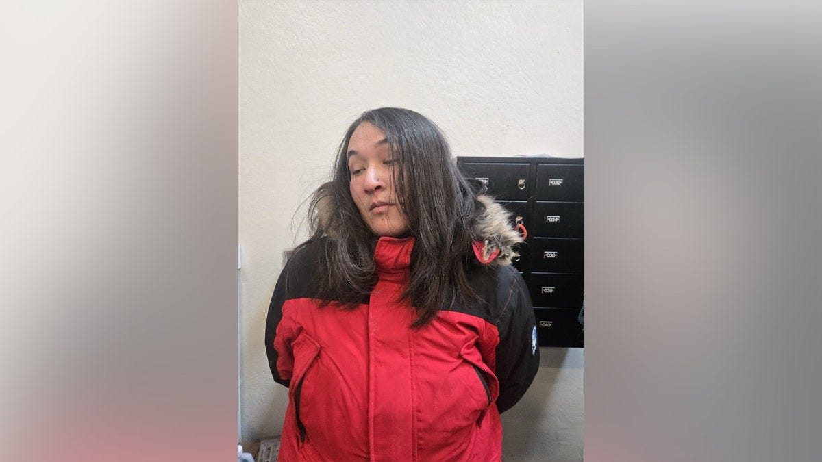 A woman wearing a red jacket looking off to the side