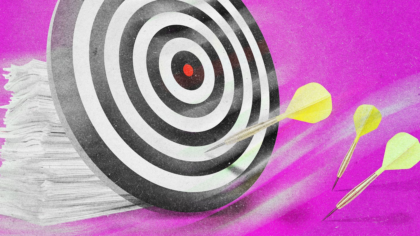a dart board against a stack of research papers with darts just shy of hitting the target a dart board against a stack of research papers with darts just shy of hitting the target