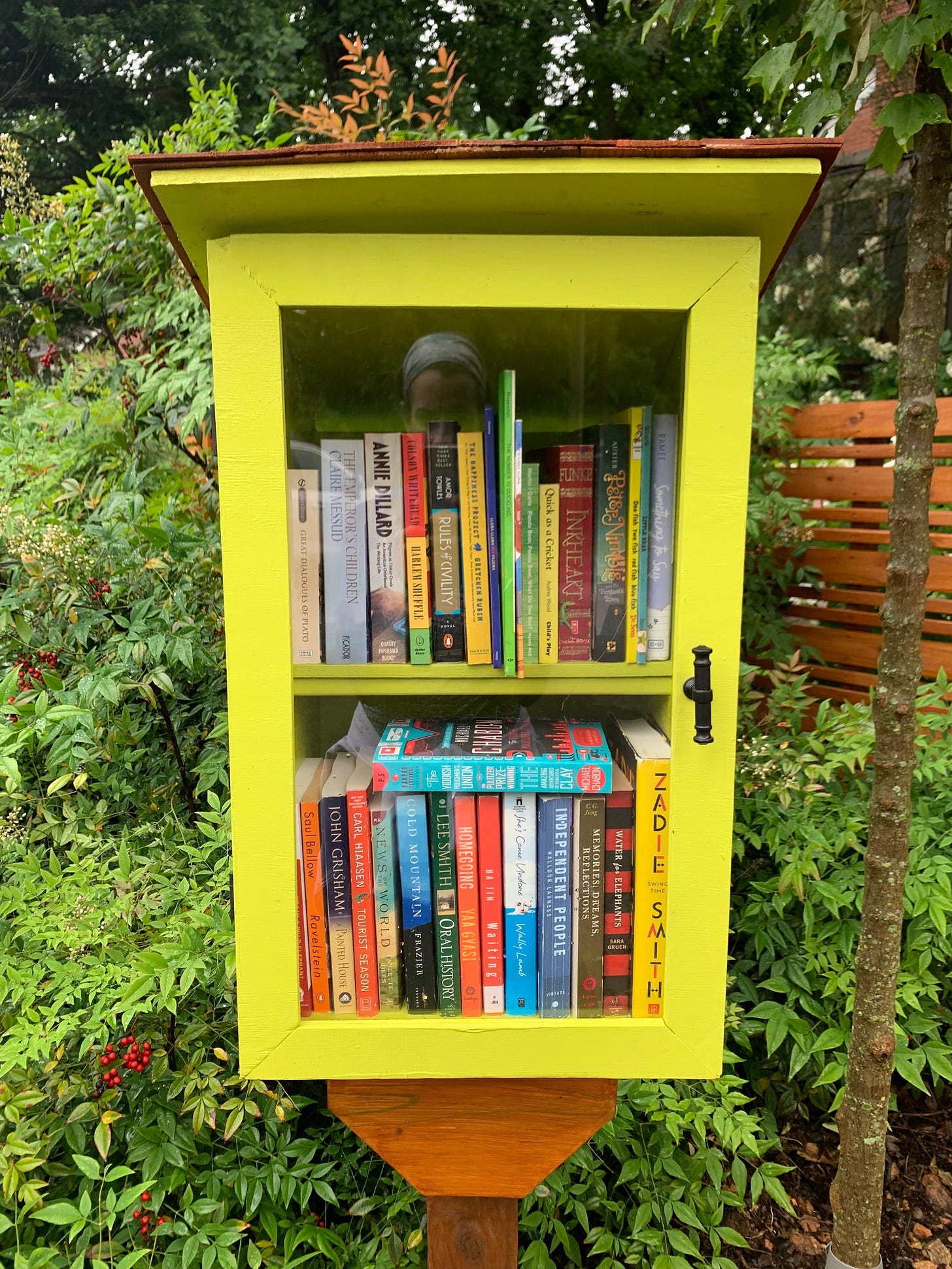 a chartreuse painted two story little book box with 15ish books inside
