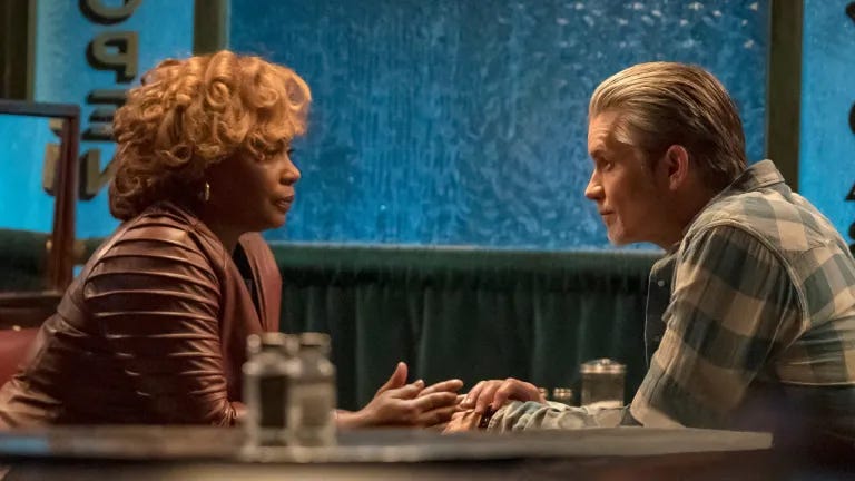 Carolyn Wilder and Raylan Givens sat across from each other at a diner table