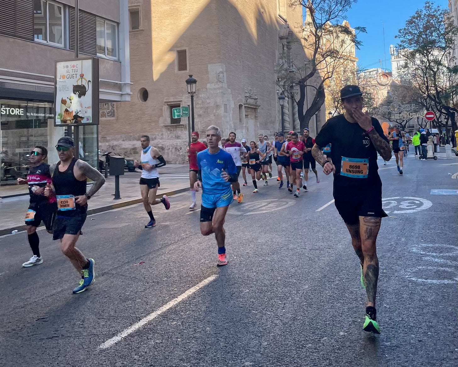 The author racing the Valencia Marathon and throwing an air kiss towards his wife Lisa