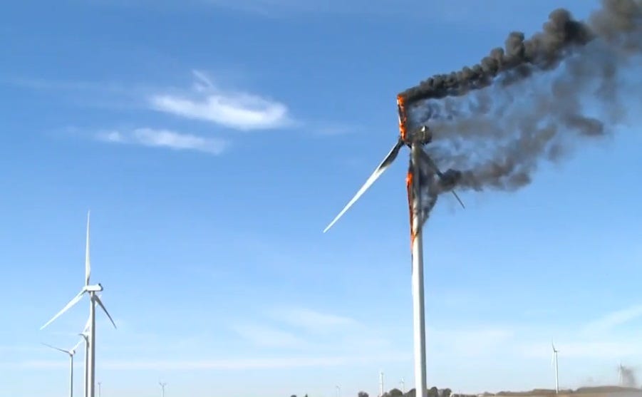 Video screenshot of a wind turbine on fire. One burning turbine blade has separated and is falling to the ground. Video screenshot of a wind turbine on fire. One burning turbine blade has separated and is falling to the ground.