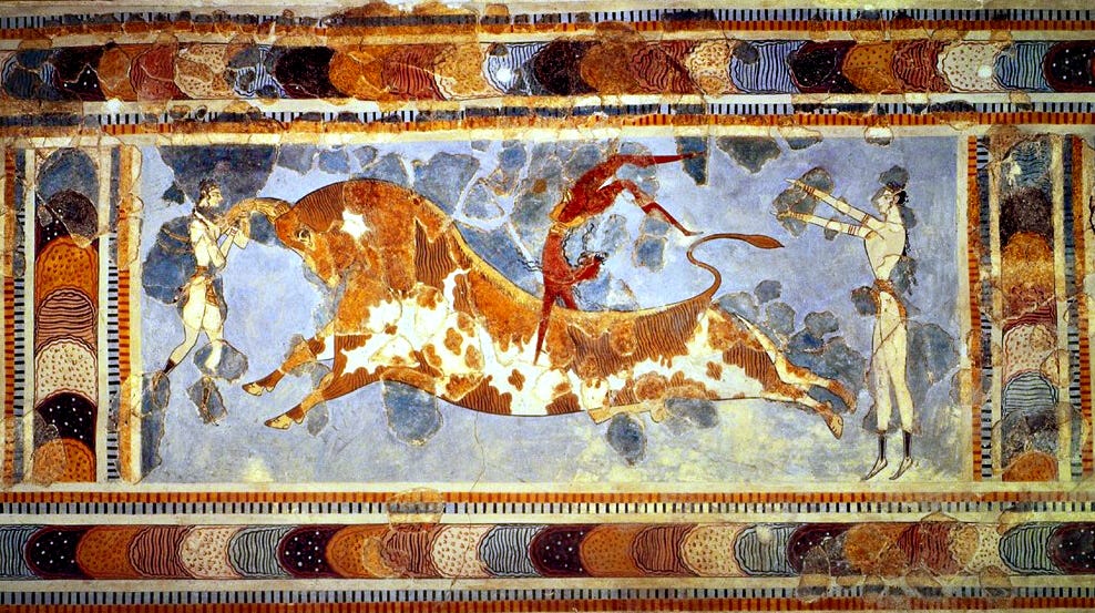 The Bull Leaper fresco from Knossos, showing three loincloth-clad athletes in various stages of leaping over a tan-and-white spotted bull. On the left, a white-skinned leaper hangs bodily from the bull's horns. In the center, a red-skinned leaper balances upside down on the bull's back. On the right, a white-skinned leaper has landed on the ground with arms raised, facing the bull's rear end. The image has a light blue background and a wide multicolor border around all four sides.