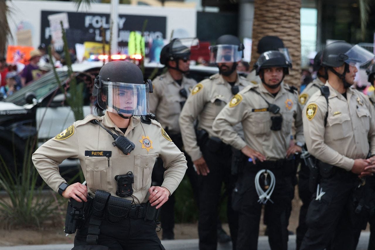 Police monitor as people take part in a "No Kings" protest in Las Vegas on Saturday.