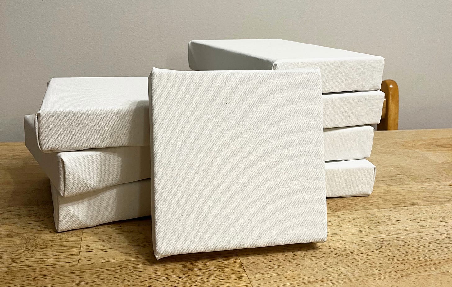 Stack of small blank canvases on my dining room table Stack of small blank canvases on my dining room table