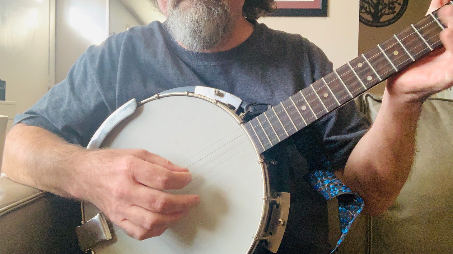 Photo of Gerard Mclean trying to play the banjo Photo of Gerard Mclean trying to play the banjo