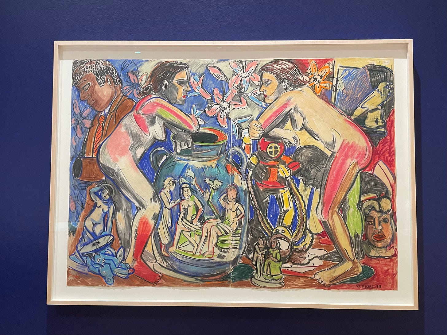 An image of Viola Frey’s Artist Mind/Studio Diptych VIII. In the center are two nude individuals, facing one another. The person on the left rests their hands atop a vase with smaller nude figures on it. The person on the right rests their hands atop an oxygen tank used for deep sea diving. Around the individuals are various objects — figurines, statues, flowers — and a man to the far left. Browns, reds, blues, pinks, white, greens, and yellows, are used throughout. An image of Viola Frey’s Artist Mind/Studio Diptych VIII. In the center are two nude individuals, facing one another. The person on the left rests their hands atop a vase with smaller nude figures on it. The person on the right rests their hands atop an oxygen tank used for deep sea diving. Around the individuals are various objects — figurines, statues, flowers — and a man to the far left. Browns, reds, blues, pinks, white, greens, and yellows, are used throughout.