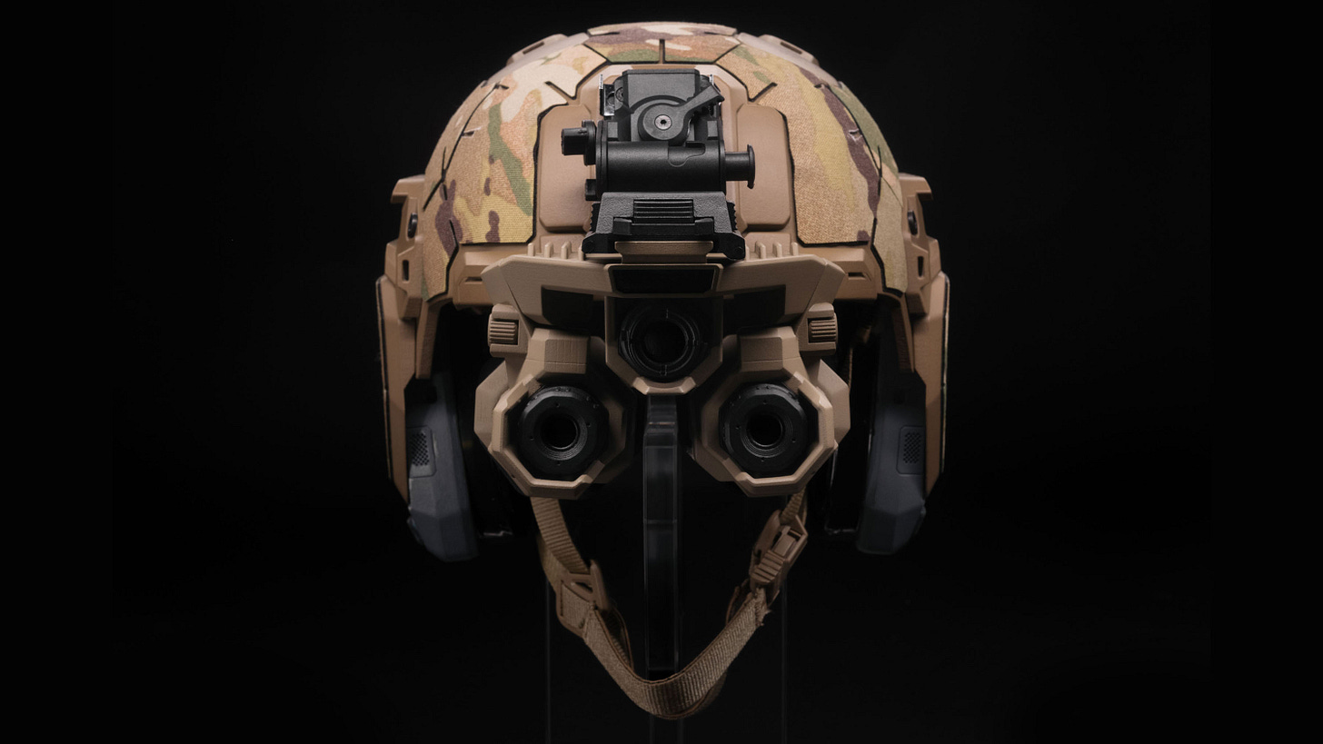 military helmet in desert camouflage with lenses where the wearer's eyes would be military helmet in desert camouflage with lenses where the wearer's eyes would be