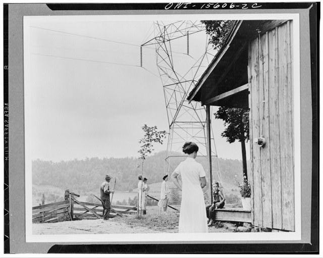 General planning. This photograph is included in the series as a vivid document on the impingement of Twentieth Century technology upon the neglected and backward rural scene. The meter on the wall of the rural shack indicates that it now receives its share of electricity from the power carried overland by the huge TVA (Tennessee Valley Authority) transmission line. TVA program must resolve the conflict between between modern and ancient ways of life so that individuals, similar to those which are shown in the picture, will be benefited General planning. This photograph is included in the series as a vivid document on the impingement of Twentieth Century technology upon the neglected and backward rural scene. The meter on the wall of the rural shack indicates that it now receives its share of electricity from the power carried overland by the huge TVA (Tennessee Valley Authority) transmission line. TVA program must resolve the conflict between between modern and ancient ways of life so that individuals, similar to those which are shown in the picture, will be benefited