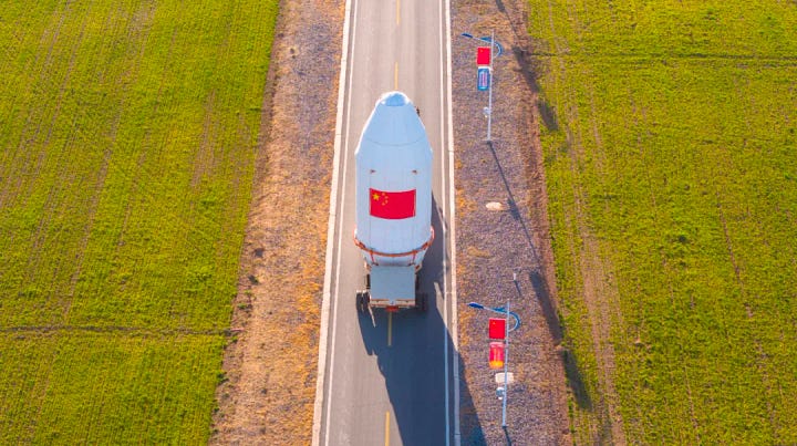 The first-stage, second-stage, and fairing for the Long March 2C launch vehicle heading to and being stacked ahead of the launch mission.