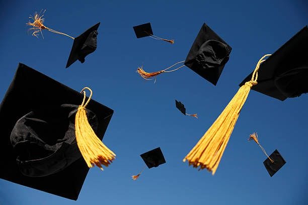 Graduation Caps Thrown in the Air  graduation stock pictures, royalty-free photos & images