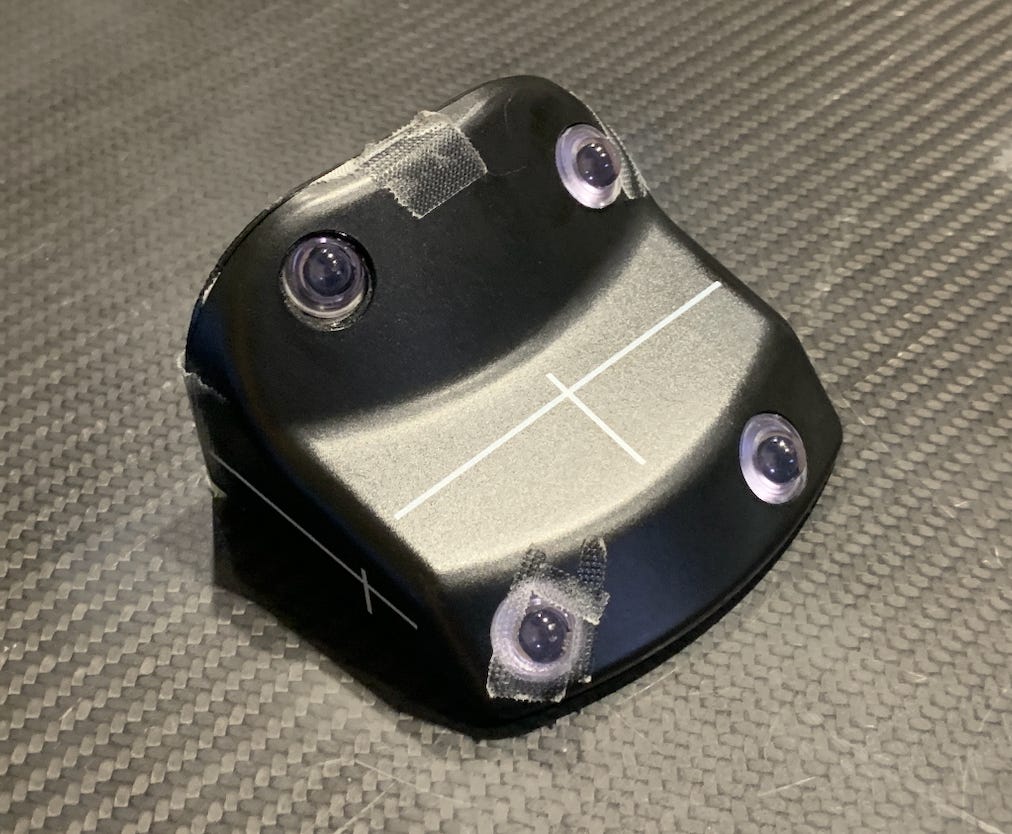 A square plastic black and white device used to monitor breathing during radiation. 